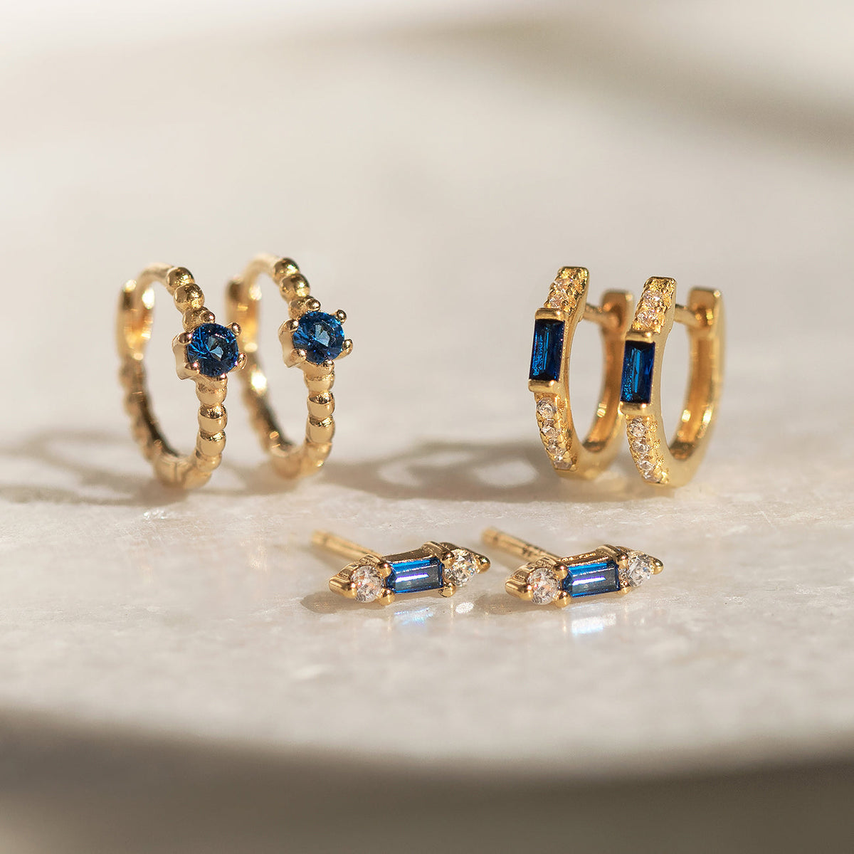 Boucles d'oreilles Huggie en baguette (Saphir bleu)