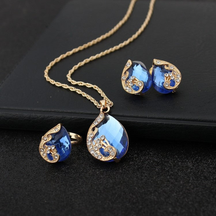 Pia – Ensemble de bijoux avec collier et boucles d'oreilles en cristal bleu et doré