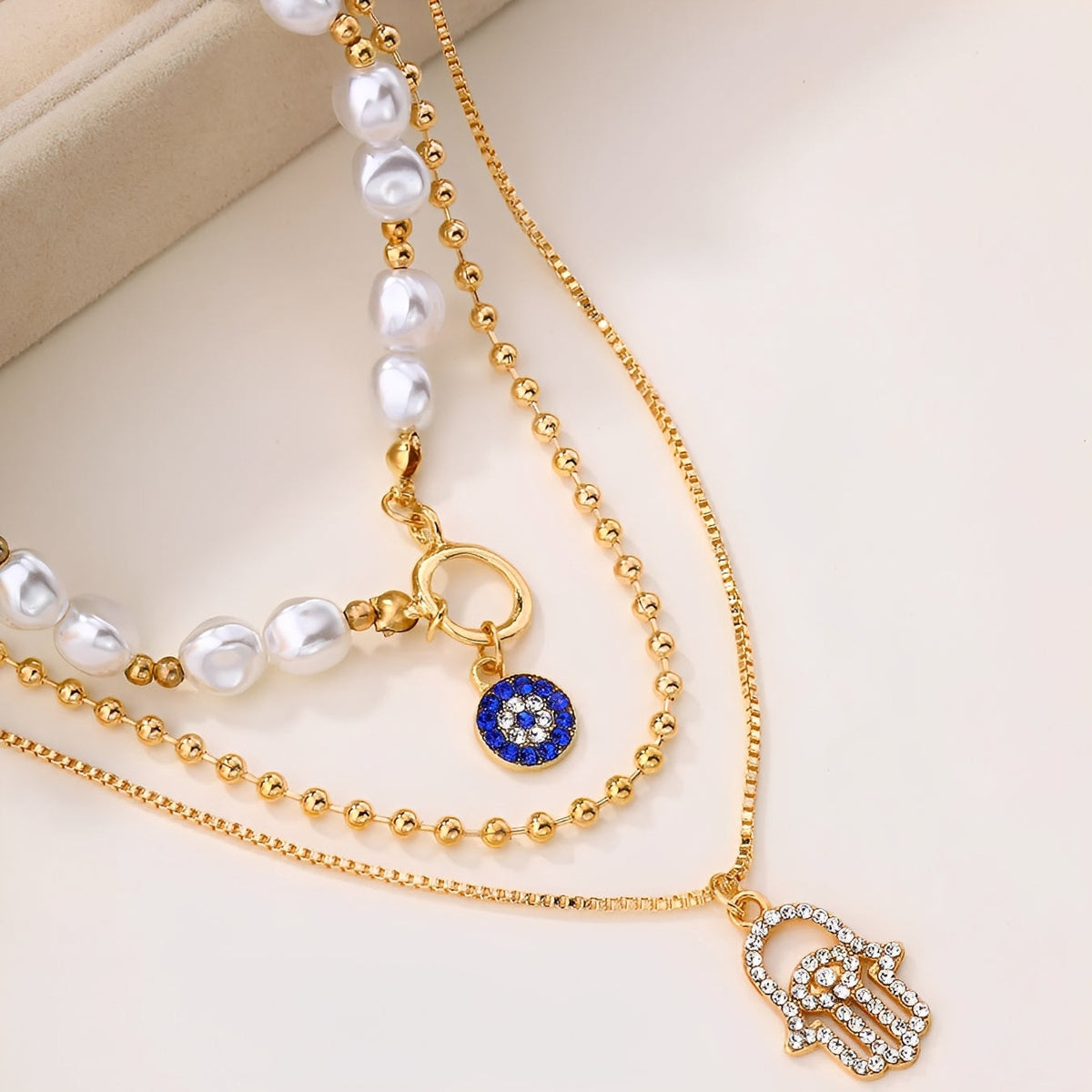 Nadia – Collier avec plusieurs rangées de perles et main de Hamsa